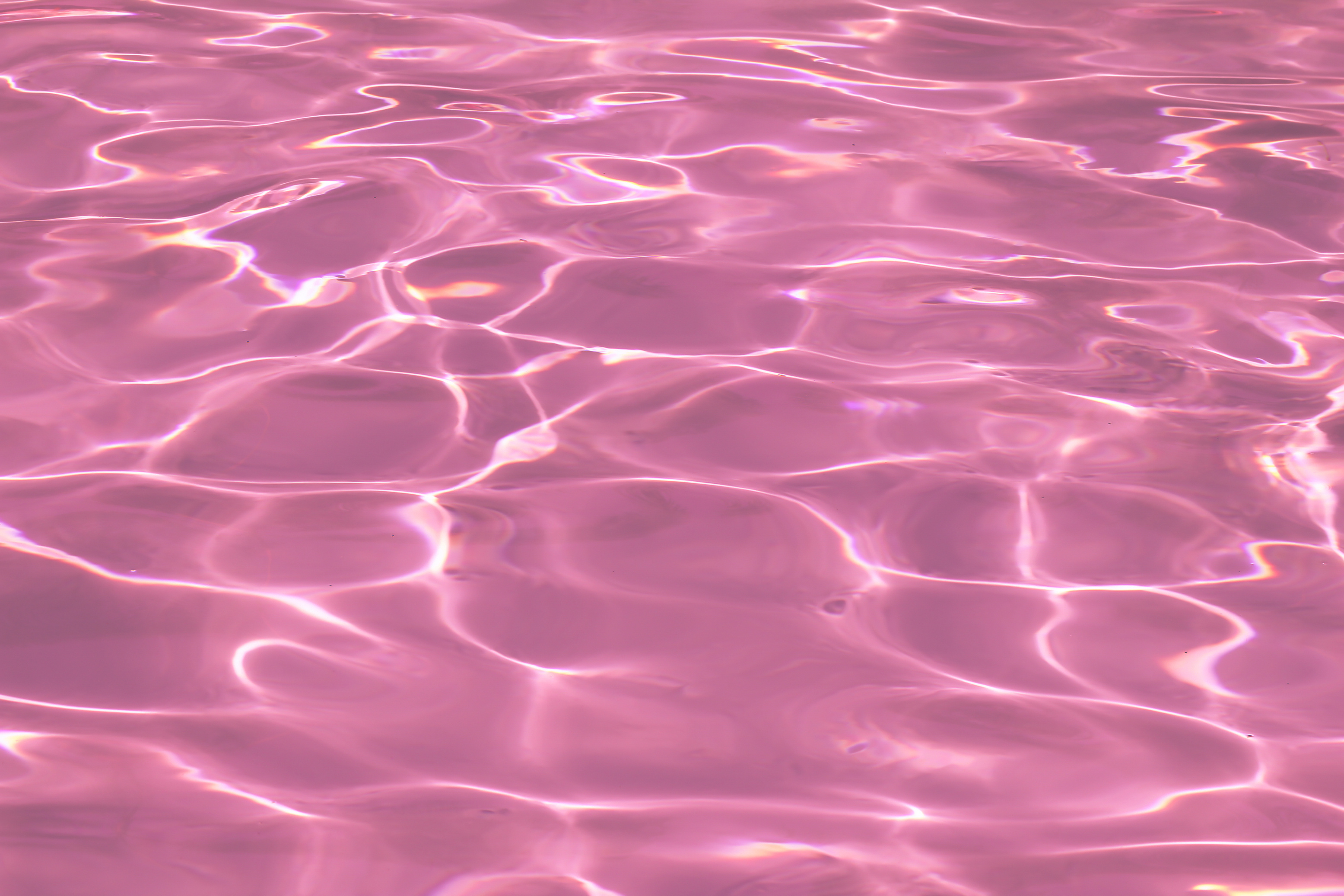 pink pool water with sun reflections